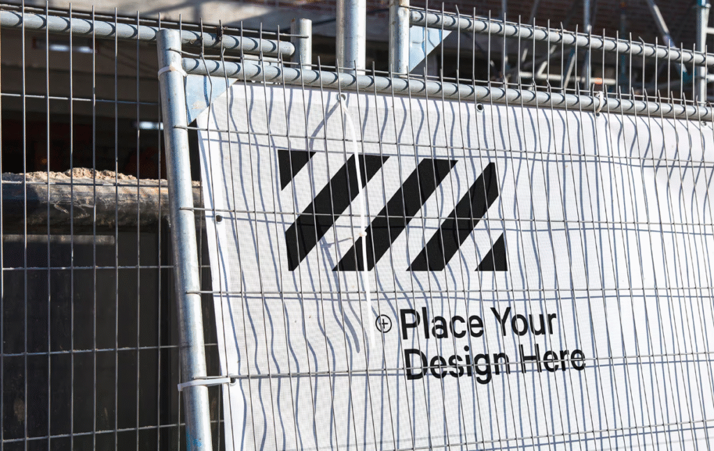 Free Construction Mesh Banner Mockup Behind Iron Fence