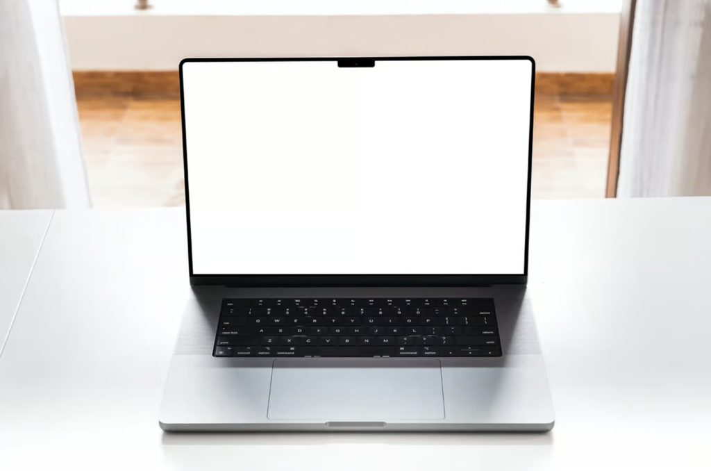 Free MacBook Pro on White Table Mockup