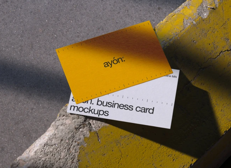 Two Overlapping Business Card Mockups on Concrete Surface