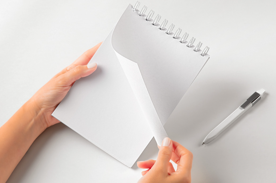 Hands Holding Spiral notebook PSD Mockup