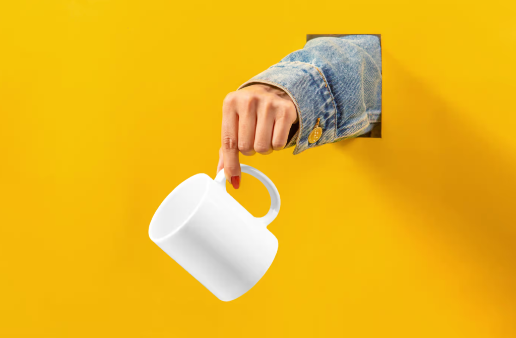 Cup with Hand Mockup Free Download