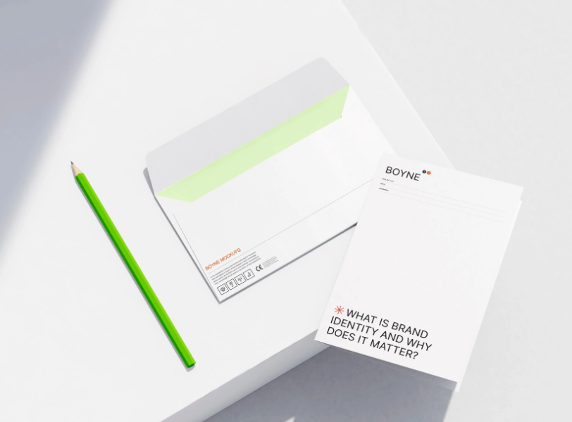 Letterhead Mockup with Green Pencil on White Surface